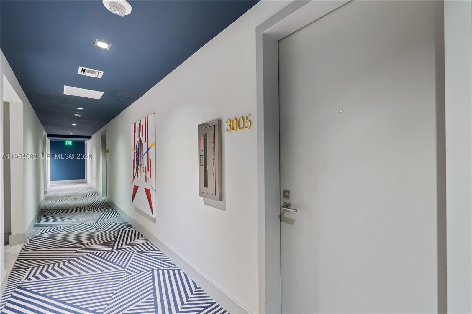 55 Southwest 9th Street, Unit 3005 Miami, FL 33130 - Photo 23 of 23 a view of a hallway with a white door and wooden floor