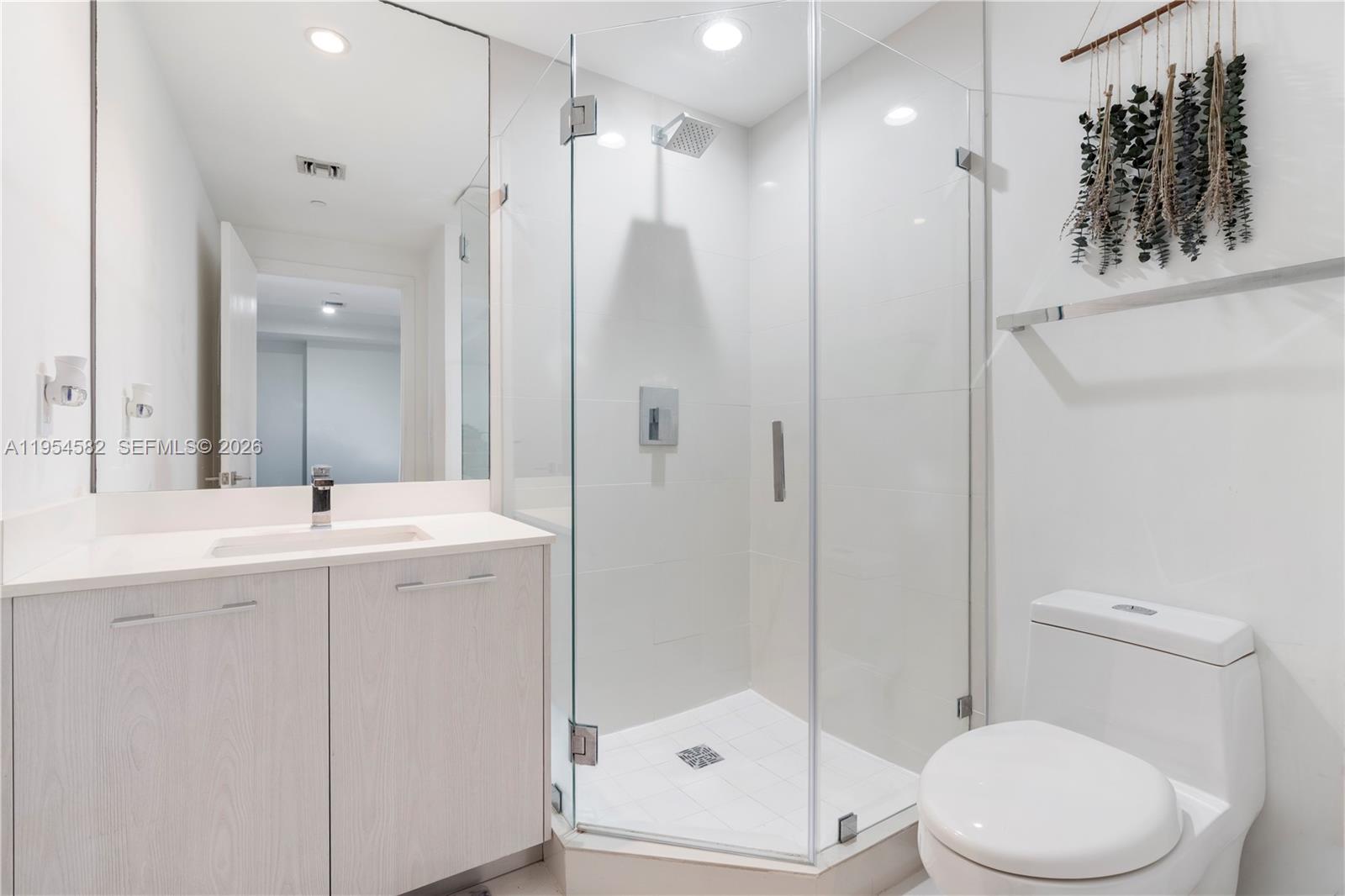 55 Southwest 9th Street, Unit 3005 Miami, FL 33130 - Photo 7 of 23 a bathroom with a sink a toilet and shower