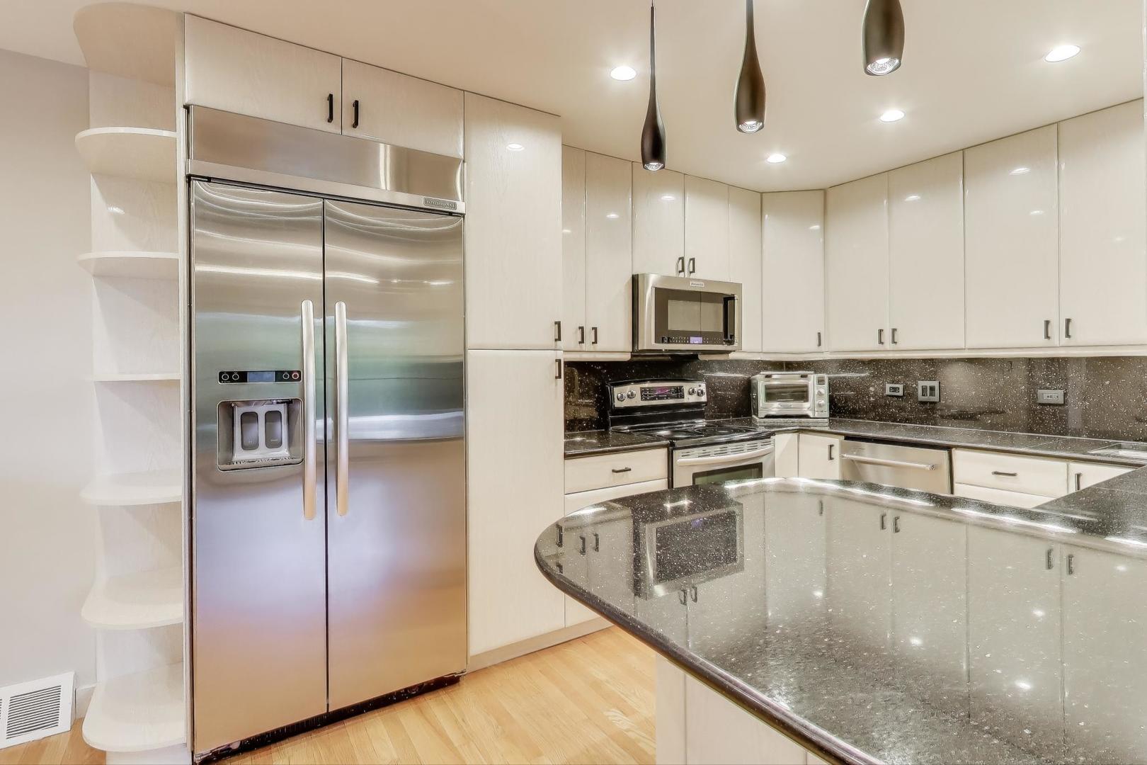 300 Boardwalk Place Park Ridge, IL 60068 - Photo 11 of 52 a kitchen with stainless steel appliances granite countertop a refrigerator a stove a sink and a microwave
