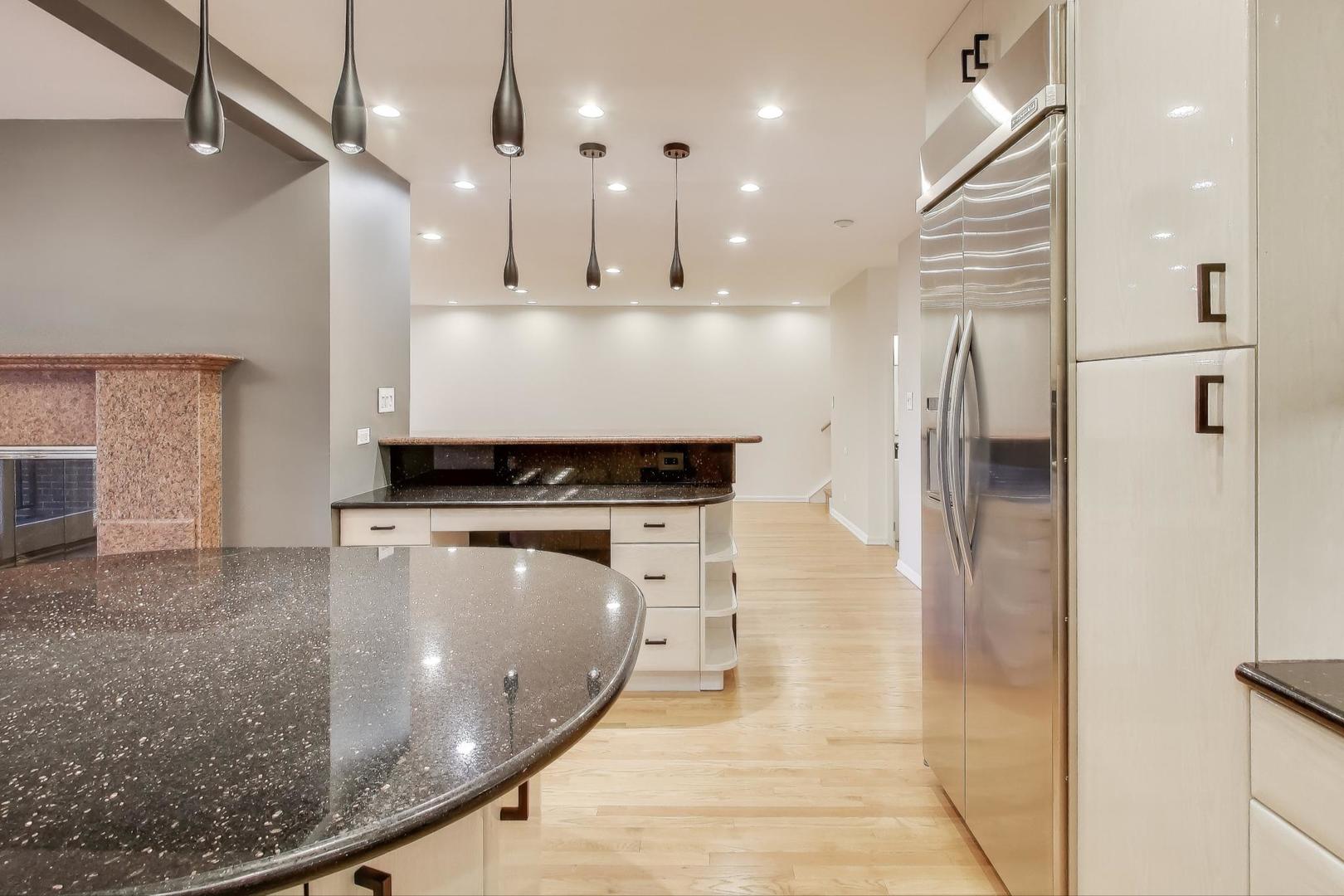 300 Boardwalk Place Park Ridge, IL 60068 - Photo 12 of 52 a view of a kitchen with a sink and a refrigerator
