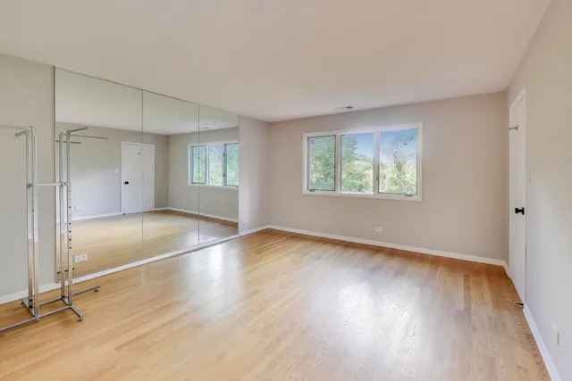 a view of a room with wooden floor