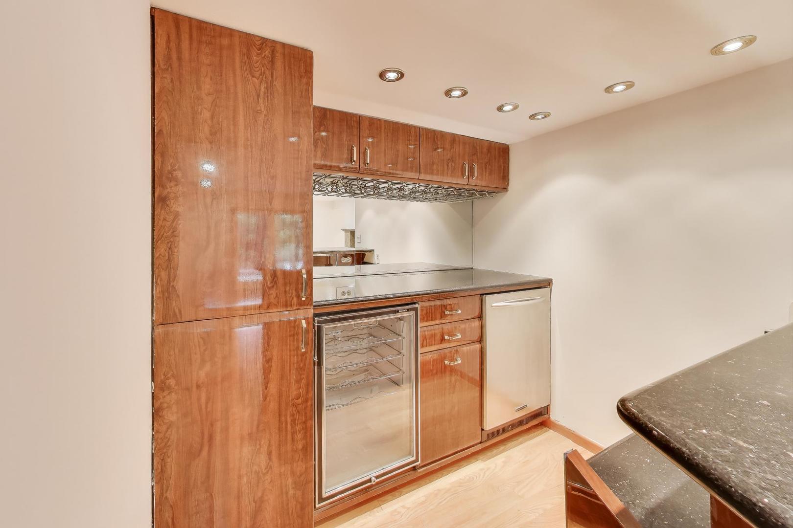 300 Boardwalk Place Park Ridge, IL 60068 - Photo 37 of 52 a kitchen with stainless steel appliances granite countertop a sink and a refrigerator
