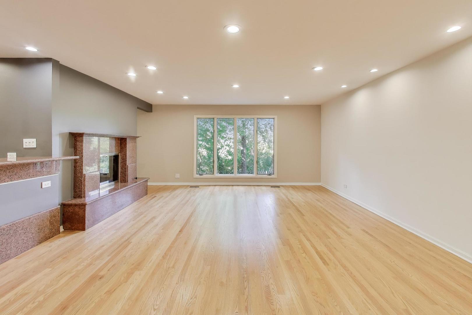 300 Boardwalk Place Park Ridge, IL 60068 - Photo 4 of 52 a view of empty room with wooden floor and fan