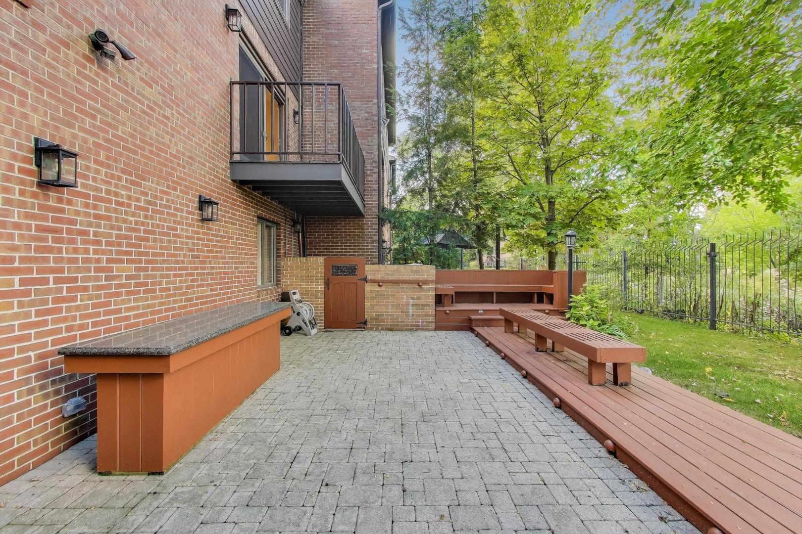 300 Boardwalk Place Park Ridge, IL 60068 - Photo 46 of 52 a backyard of a house with barbeque oven and trees
