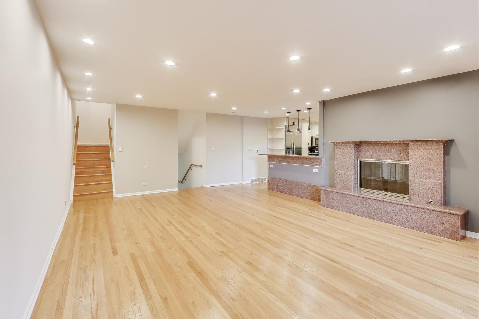 300 Boardwalk Place Park Ridge, IL 60068 - Photo 6 of 52 a view of an empty room with a fireplace and a window