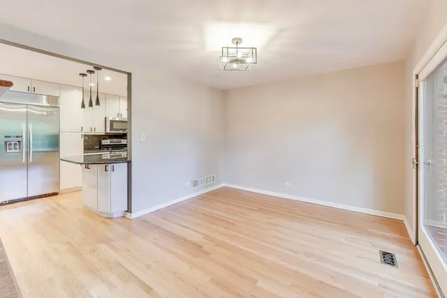 a view of a kitchen with a sink and a refrigerator