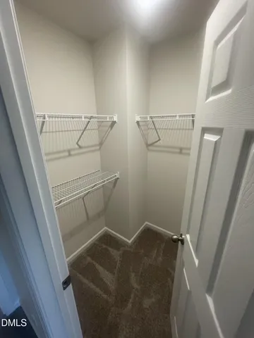 a view of a livingroom with a ceiling fan and window