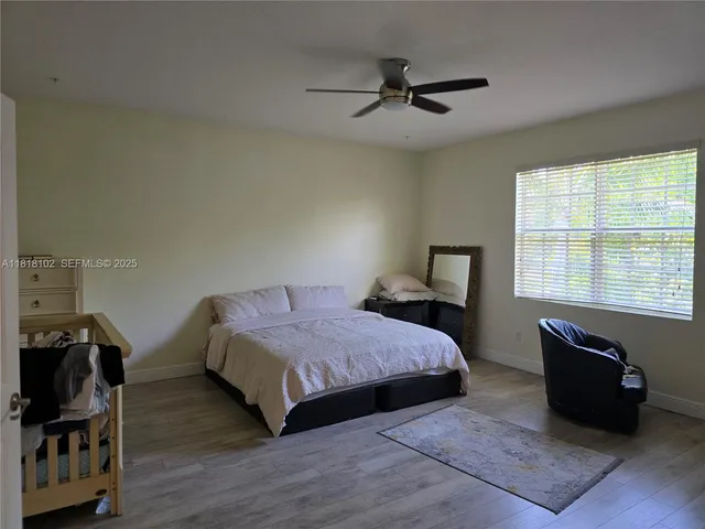 a bedroom with a bed and a tv