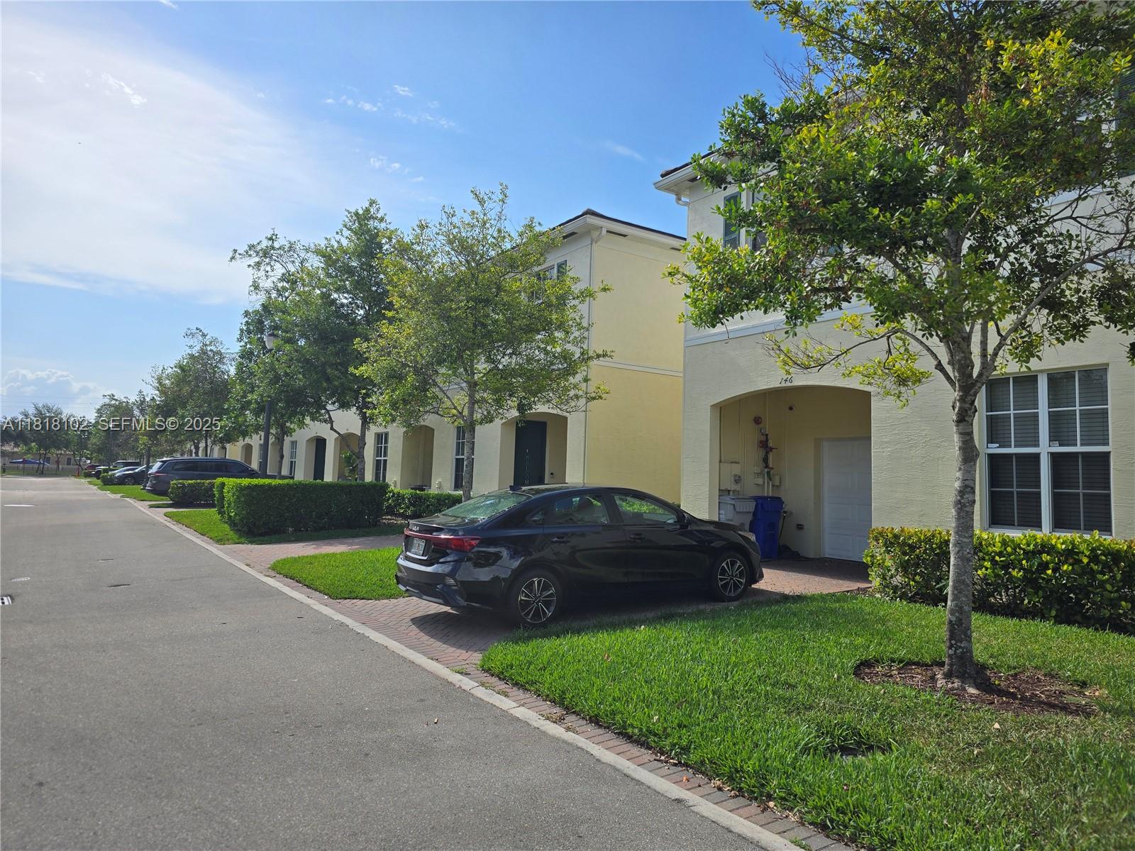 146 Southwest 7th Court Pompano Beach, FL 33060 - Photo 2 of 37 a front view of a house with a garden and trees