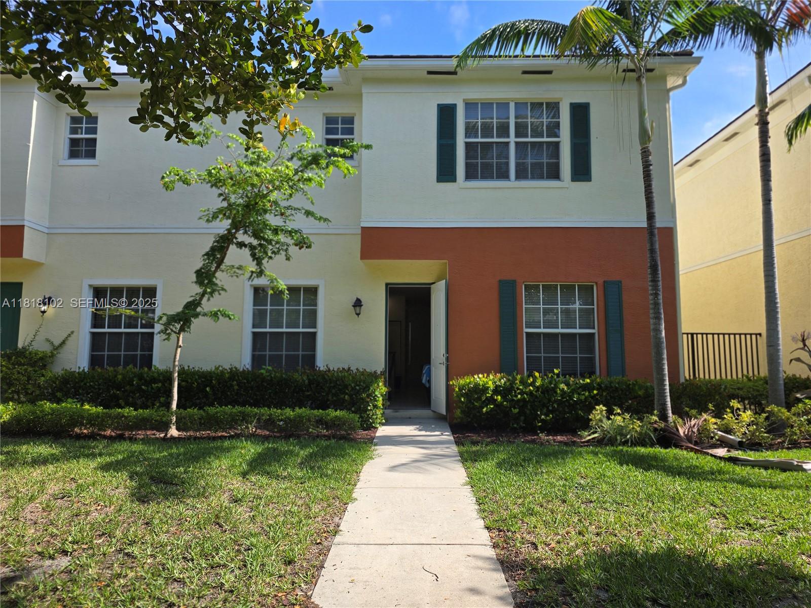 146 Southwest 7th Court Pompano Beach, FL 33060 - Photo 3 of 37 a front view of a house with garden