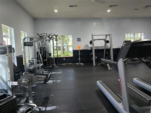 a room with gym equipment and a large window