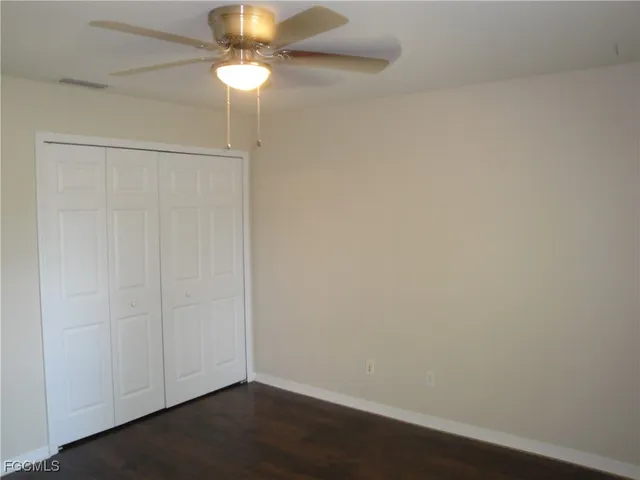 a view of an empty room with a fan