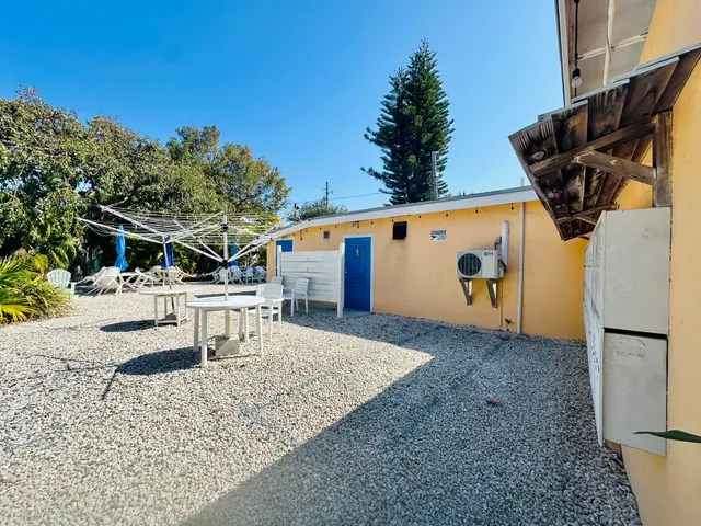 a view of a chairs and table in backyard