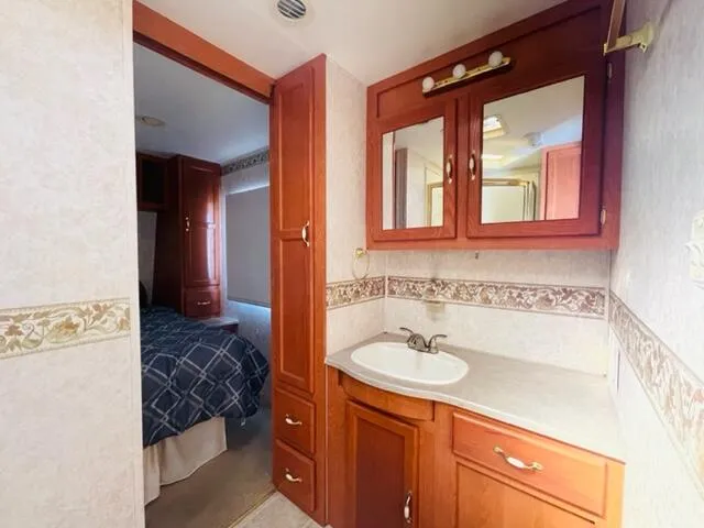 a bathroom with a sink a mirror and a shower