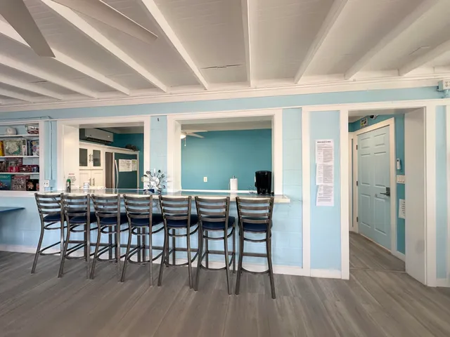 a kitchen with stainless steel appliances granite countertop a stove and a wooden floors