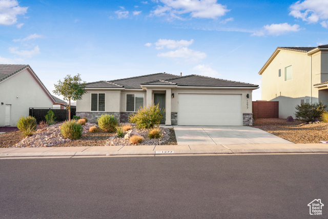 1277 Marlowe Way Washington, UT 84780 - Photo 1 of 1 Prairie-style home with stone siding, stucco siding, concrete driveway, an attached garage, and a tile roof