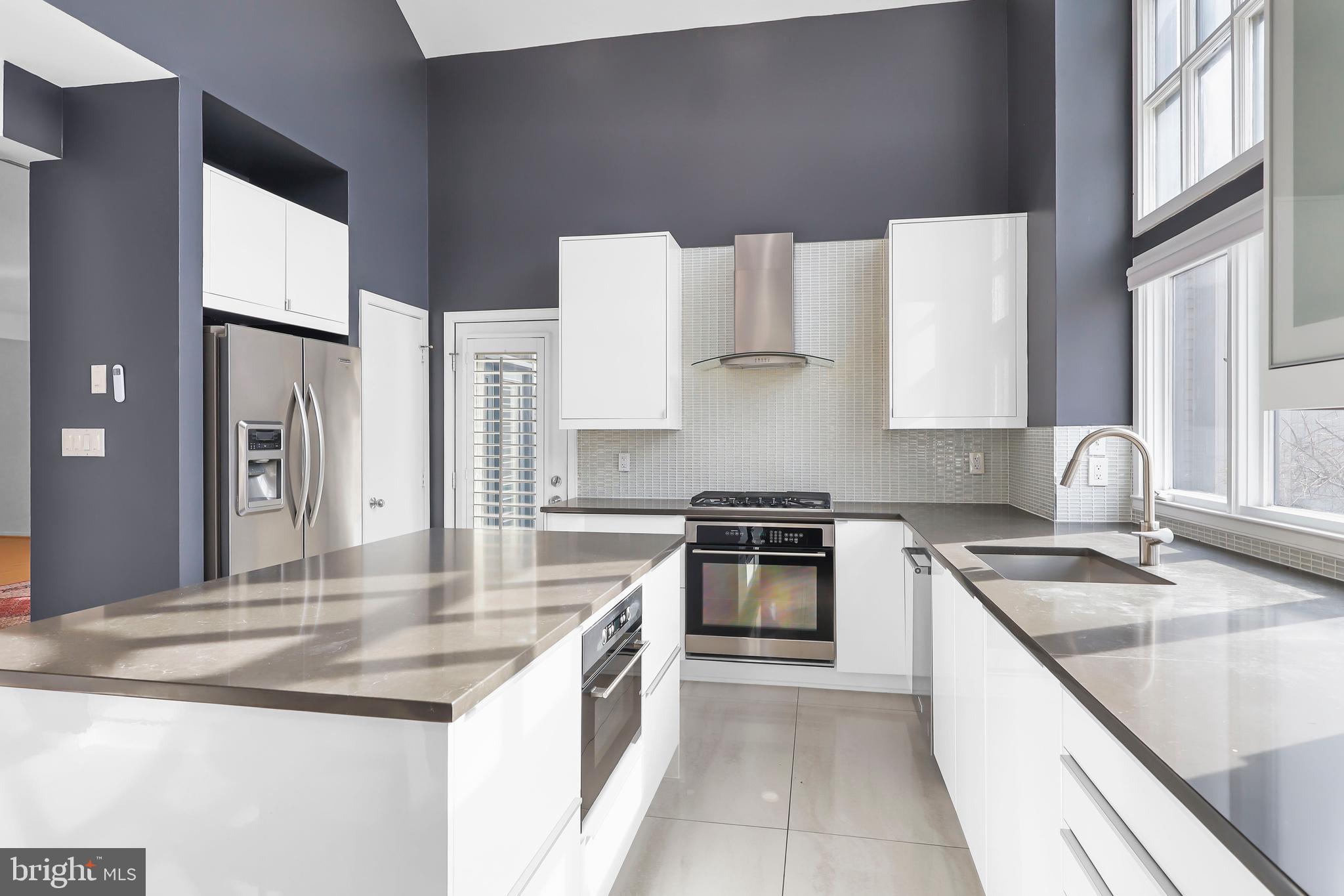 1460 Waterfront Road Reston, VA 20194 - Photo 16 of 63 a kitchen with stainless steel appliances granite countertop a sink stove and refrigerator