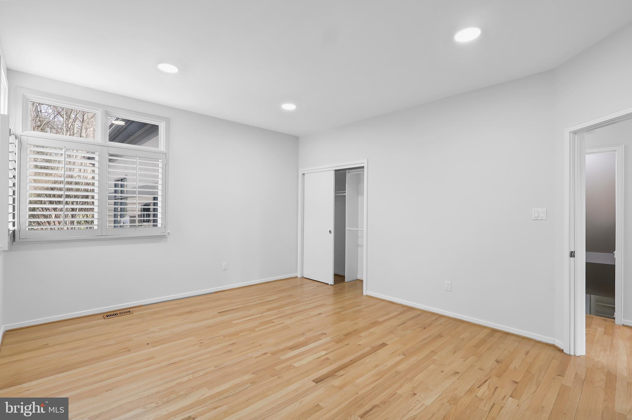 1460 Waterfront Road Reston, VA 20194 - Photo 21 of 63 a view of an empty room with wooden floor and a window