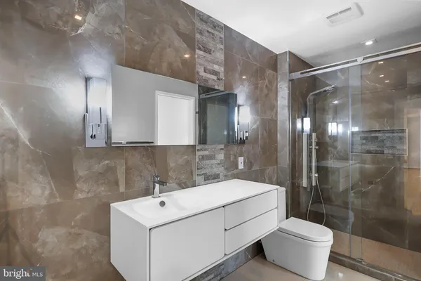 a bathroom with a glass shower door