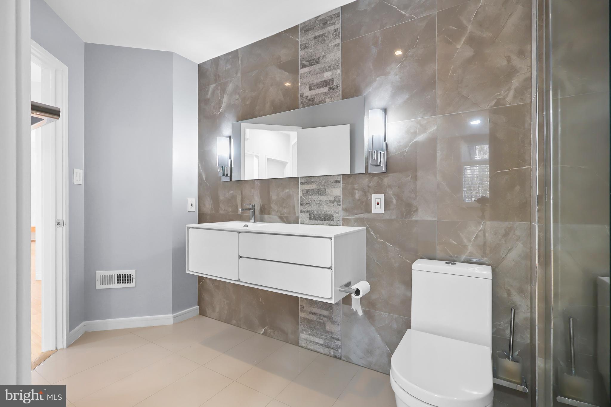 1460 Waterfront Road Reston, VA 20194 - Photo 23 of 63 a bathroom with a sink a toilet and mirror