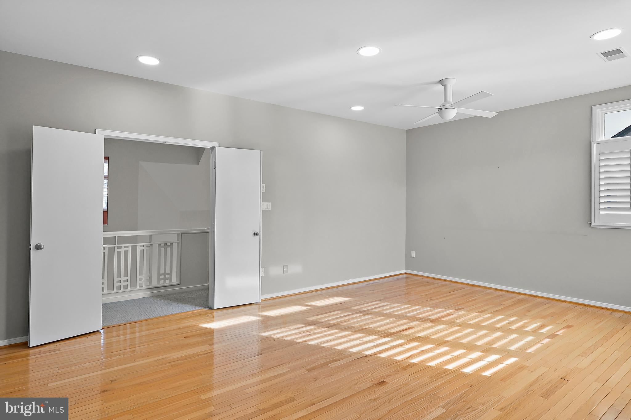 1460 Waterfront Road Reston, VA 20194 - Photo 25 of 63 an empty room with wooden floor and windows
