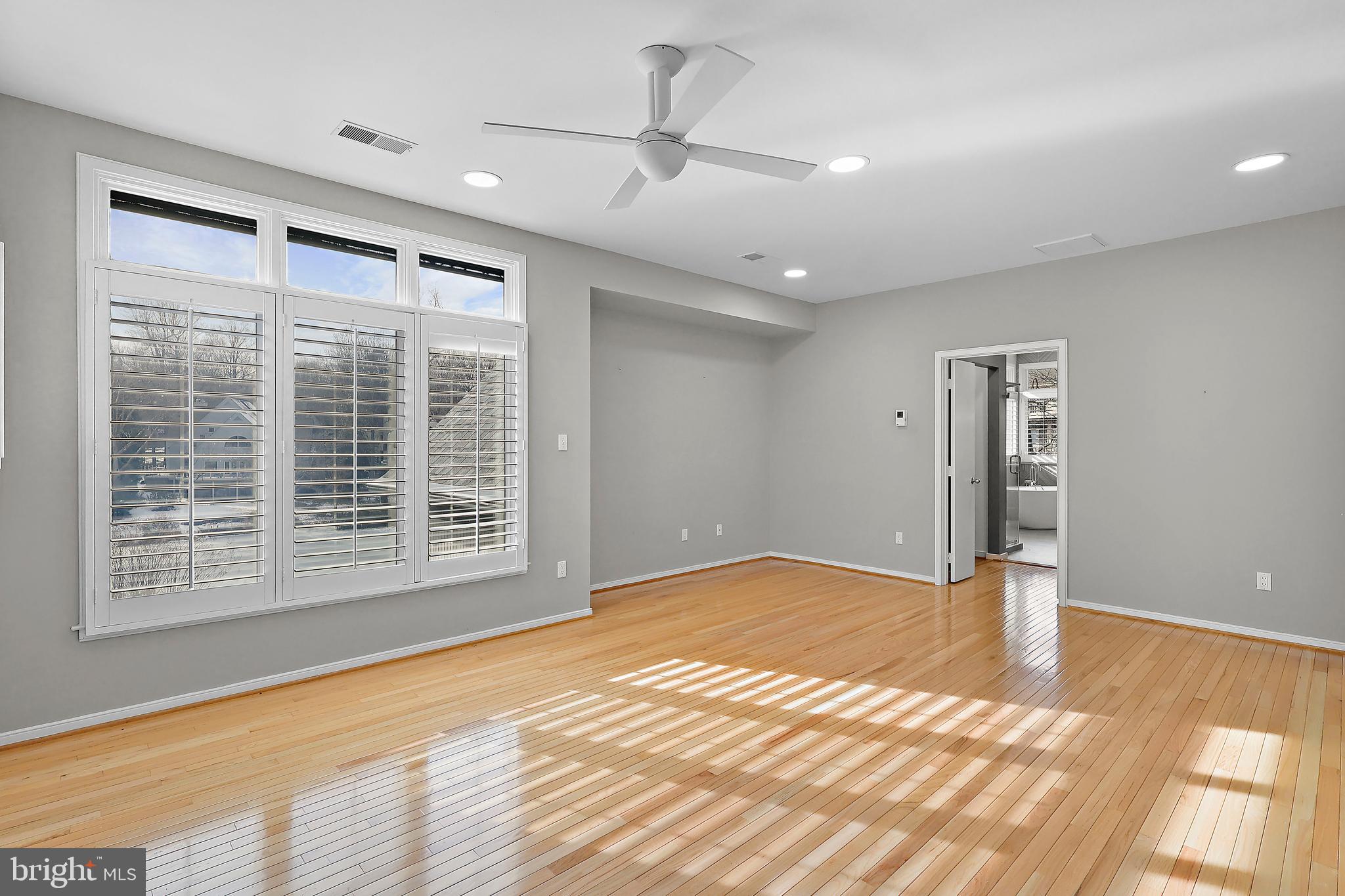 1460 Waterfront Road Reston, VA 20194 - Photo 27 of 63 a view of an empty room with wooden floor and a window