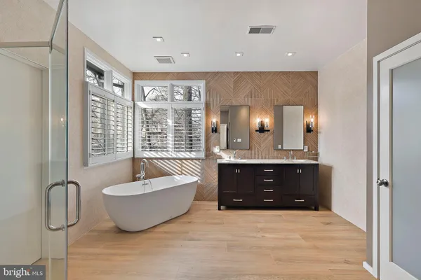 a spacious bathroom with a granite countertop tub shower and sink