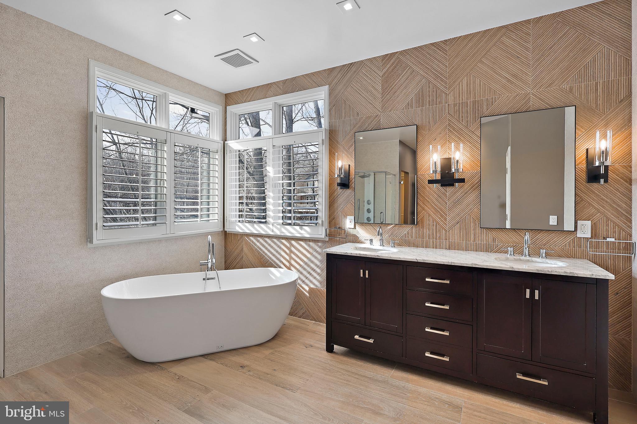 1460 Waterfront Road Reston, VA 20194 - Photo 30 of 63 a spacious bathroom with a tub double sink and mirror