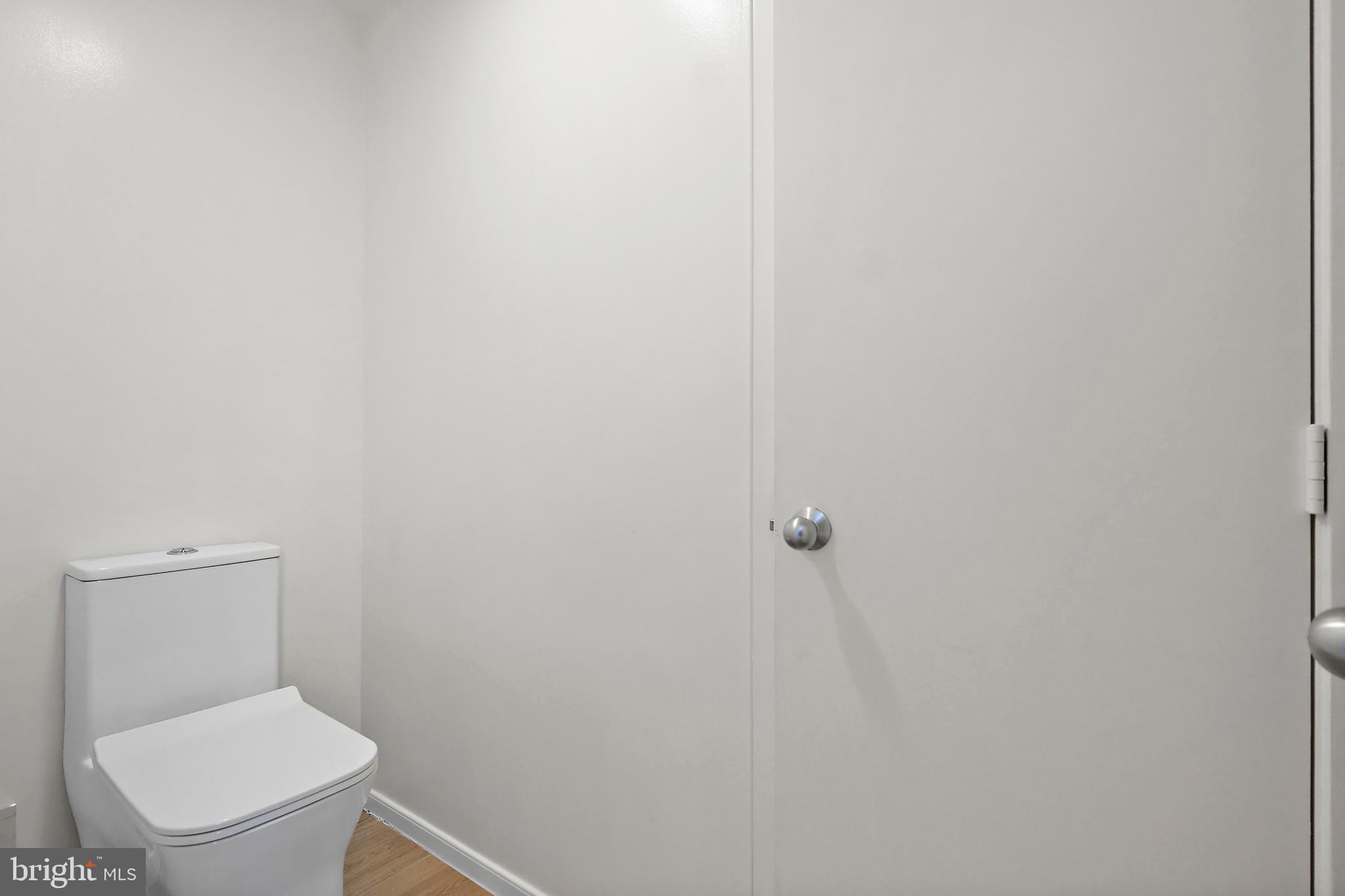 1460 Waterfront Road Reston, VA 20194 - Photo 34 of 63 a white toilet sitting next to a white wall