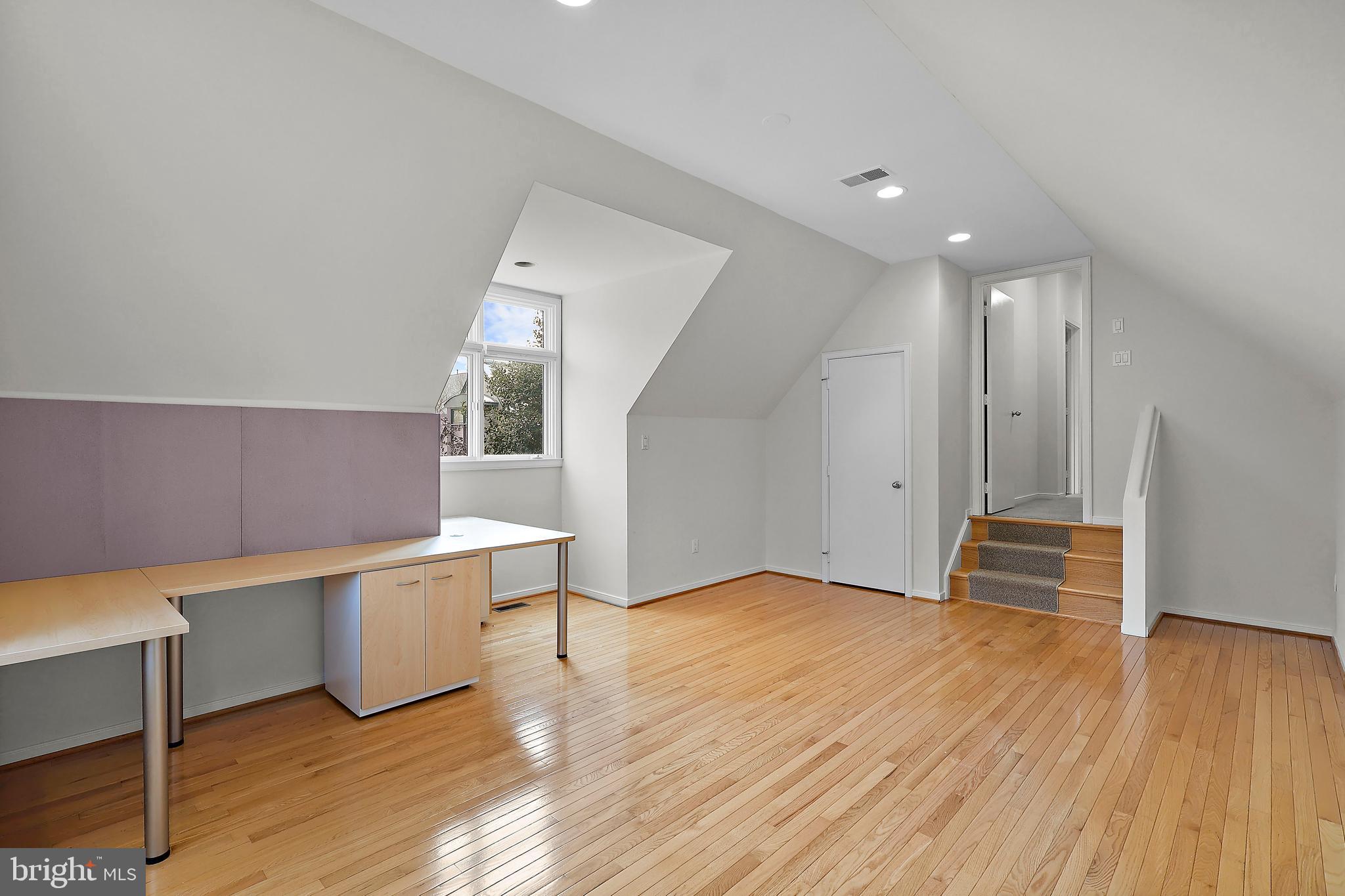 1460 Waterfront Road Reston, VA 20194 - Photo 36 of 63 a view of an empty room with wooden floor and furniture