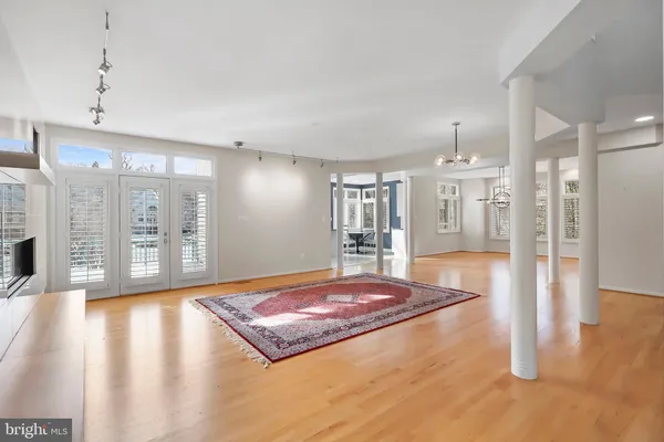 a living room with hardwood floor and a table