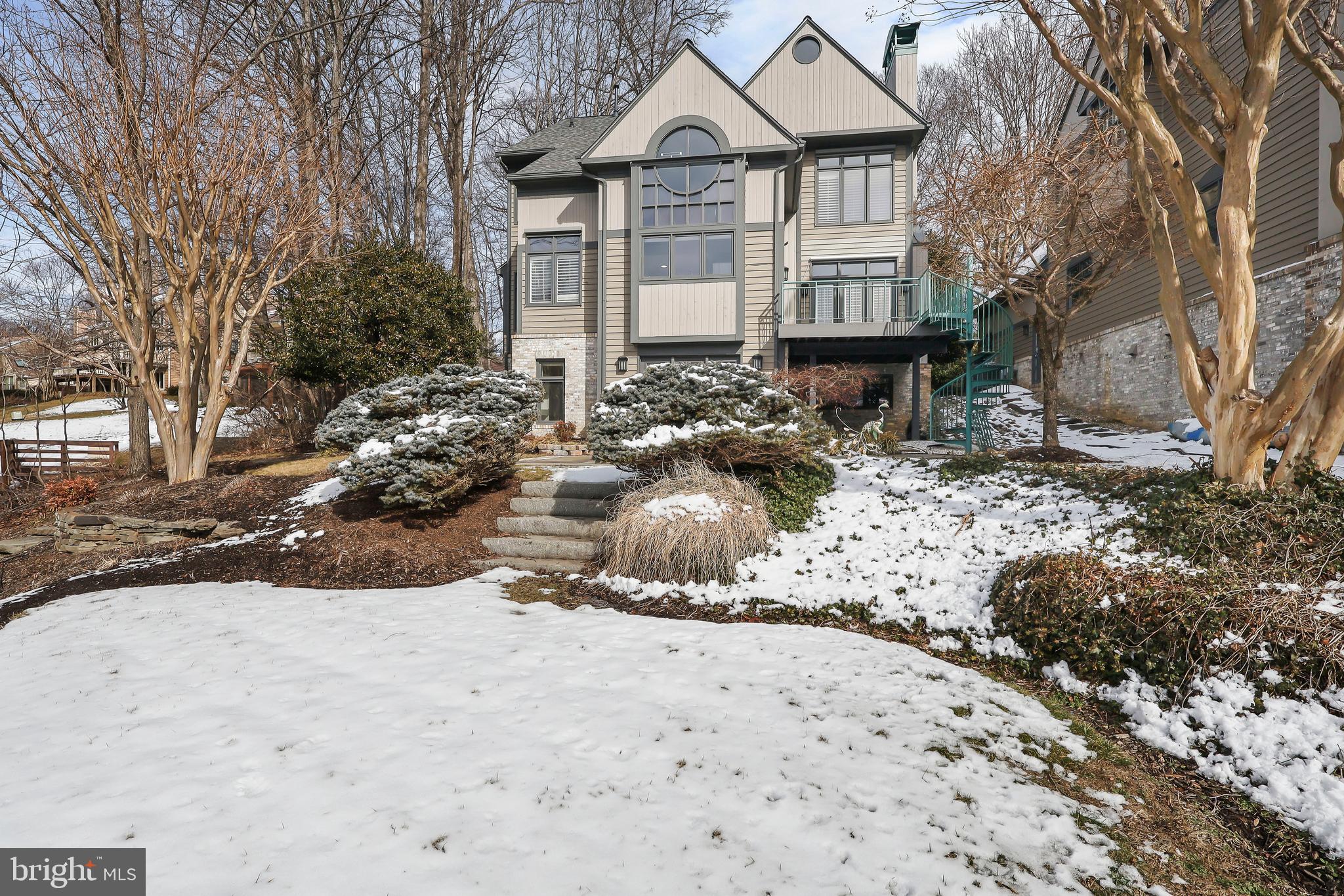 1460 Waterfront Road Reston, VA 20194 - Photo 59 of 63 a front view of a house with a yard covered in snow