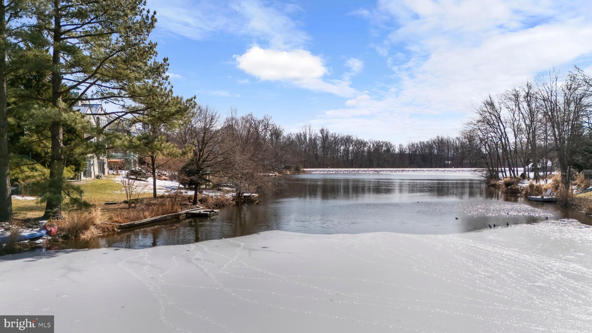 1460 Waterfront Road Reston, VA 20194 - Photo 60 of 63 a view of a lake with a house in the background