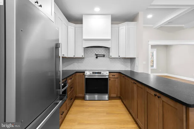 a kitchen with a sink a stove and cabinets