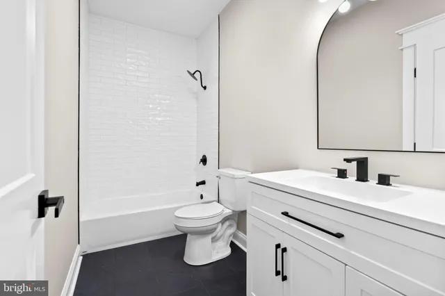 a bathroom with a sink toilet a mirror and shower