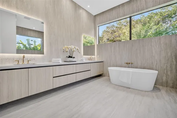 a living room with furniture potted plant and a large mirror