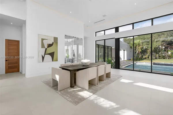 a living room with lots of furniture and a painting on the wall