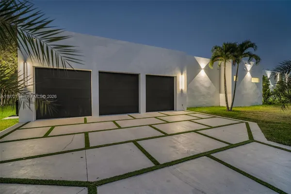 an aerial view of residential houses with outdoor space and trees