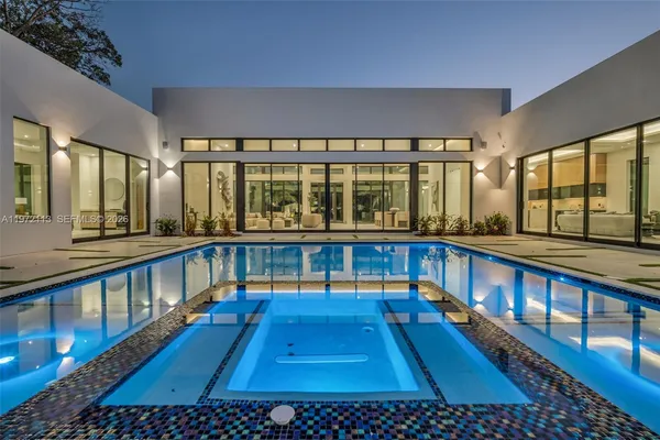 a view of a yard with swimming pool and wooden bench