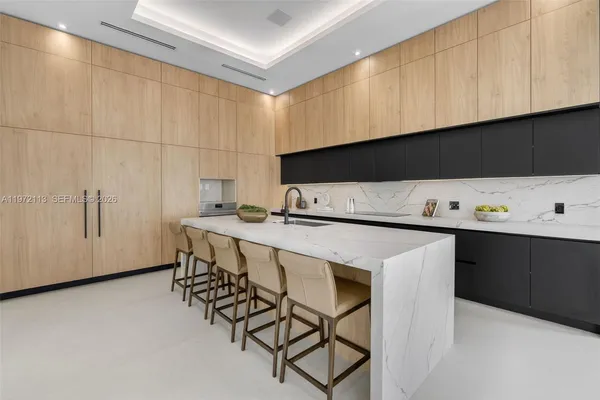 a kitchen with counter top space and living room