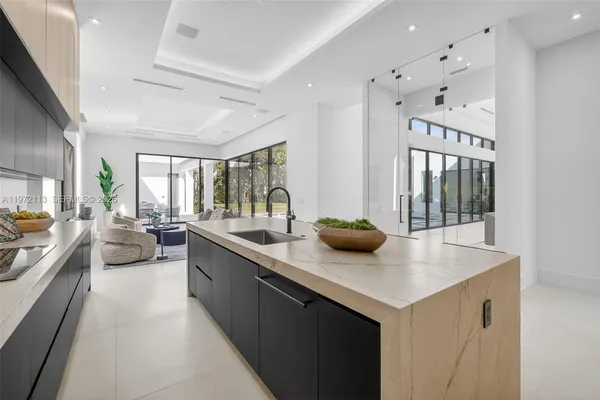 a kitchen with stainless steel appliances a sink stove and cabinets
