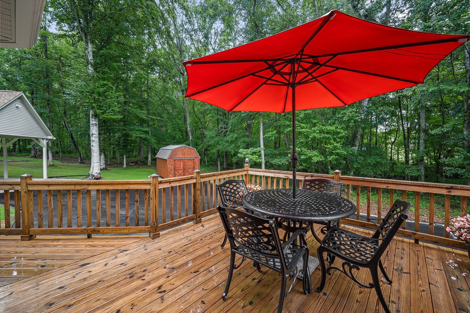 715 Old Rock Island Road Rock Island, TN 38581 - Photo 35 of 48 a patio with wooden floor a yard a table and chairs
