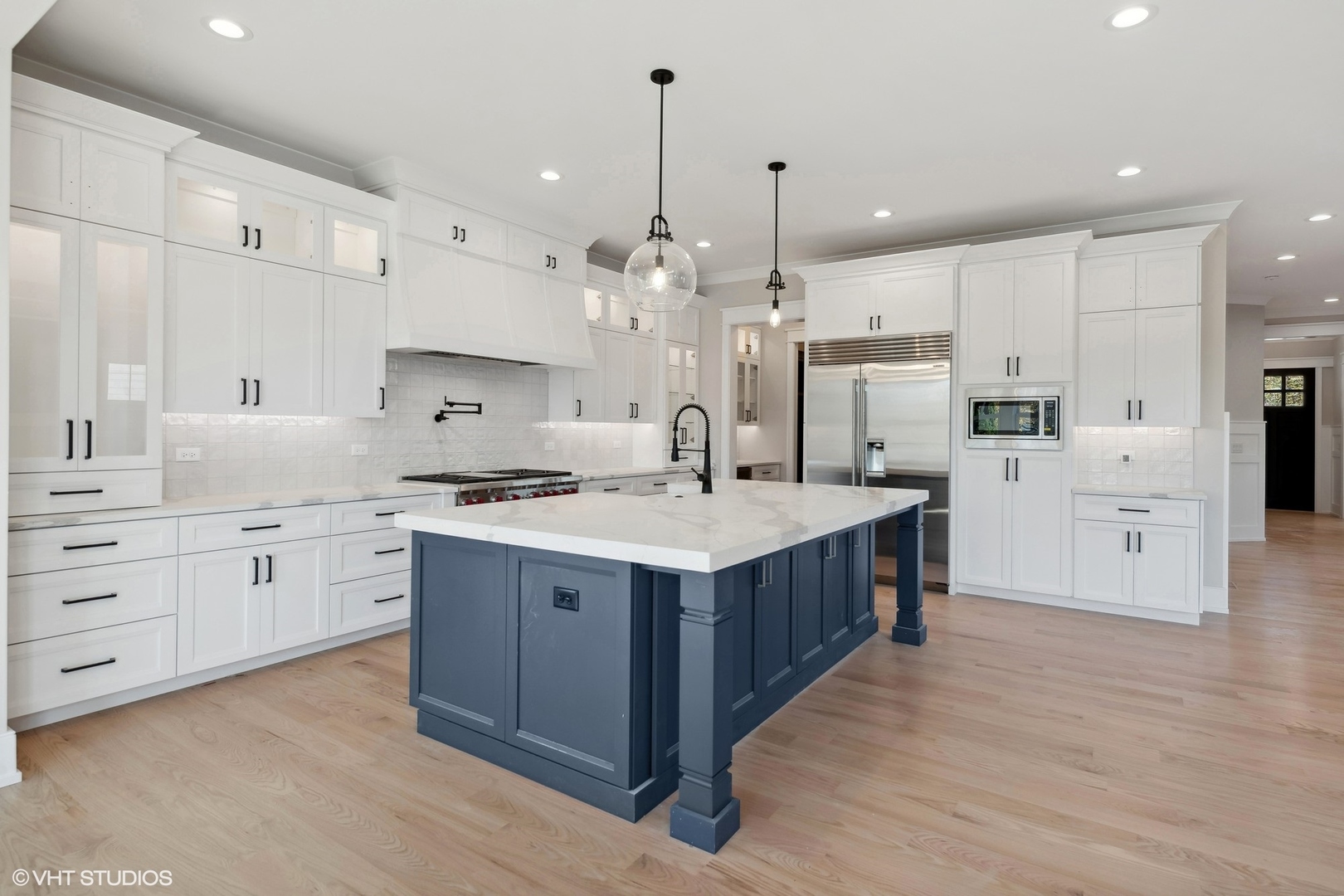 648 Saylor Avenue Elmhurst, IL 60126 - Photo 11 of 27 a kitchen with stainless steel appliances kitchen island granite countertop a wooden floor and a sink