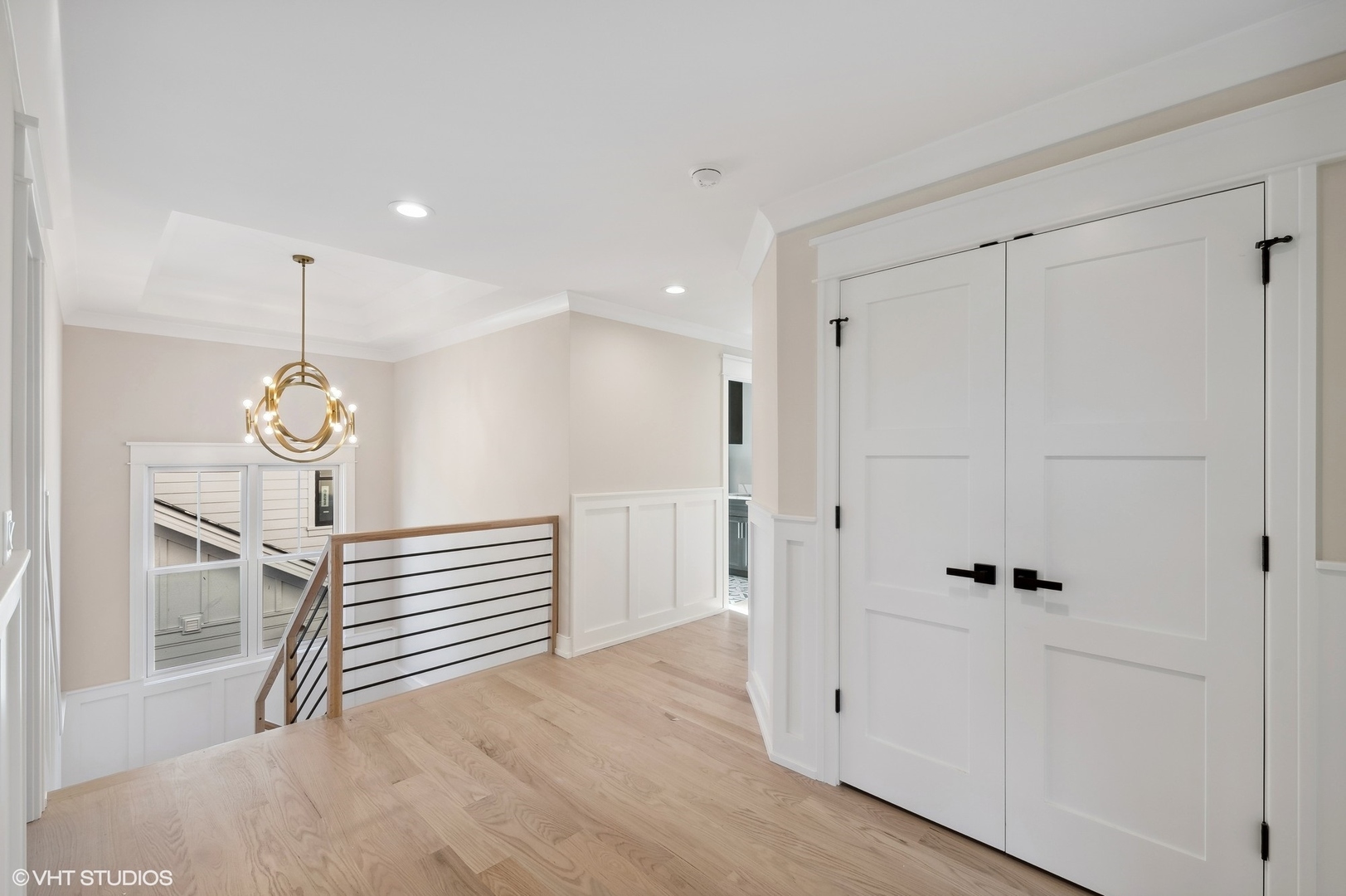 648 Saylor Avenue Elmhurst, IL 60126 - Photo 16 of 27 a view of a hallway with wooden floor and chandelier