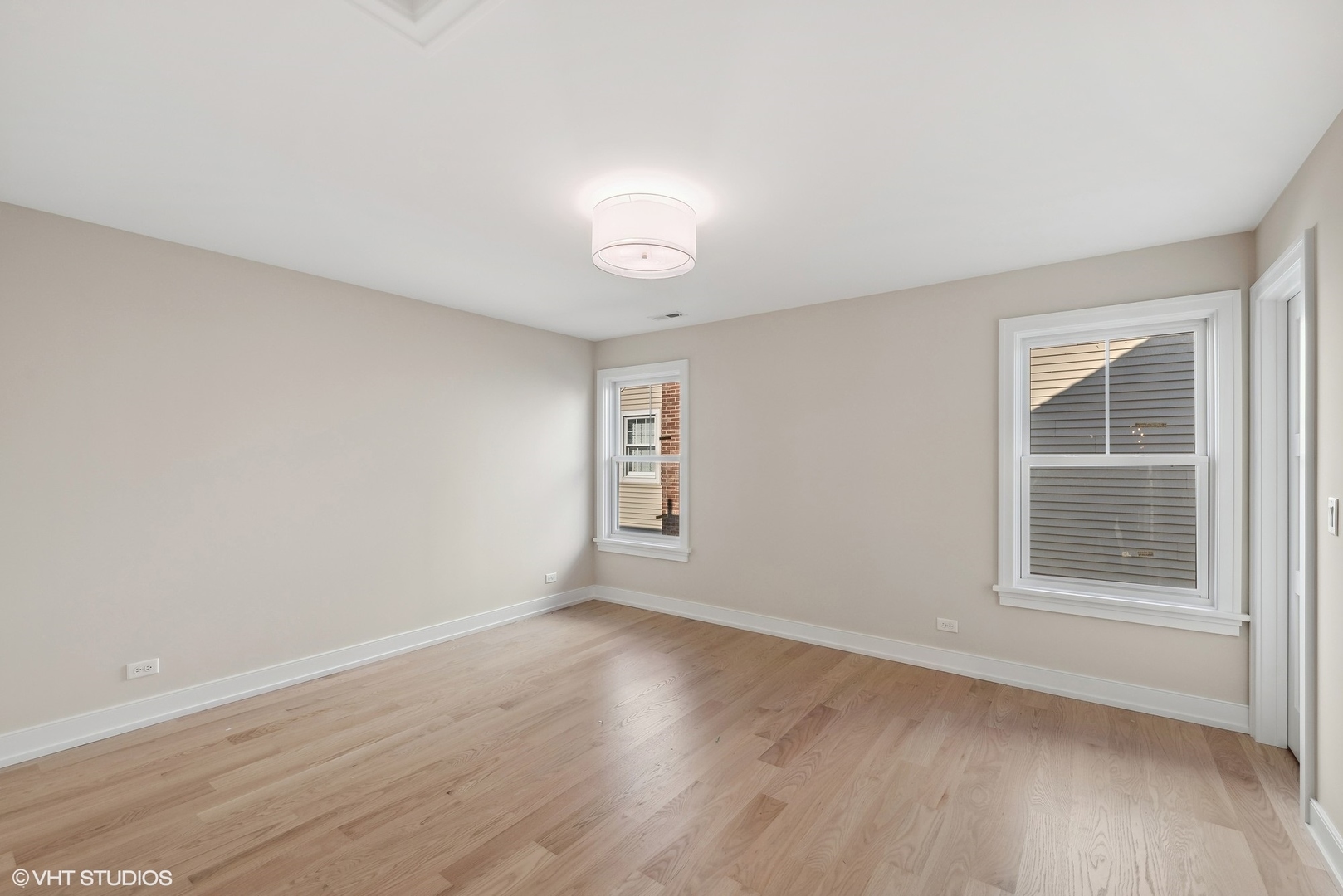 648 Saylor Avenue Elmhurst, IL 60126 - Photo 24 of 27 an empty room with wooden floor and windows