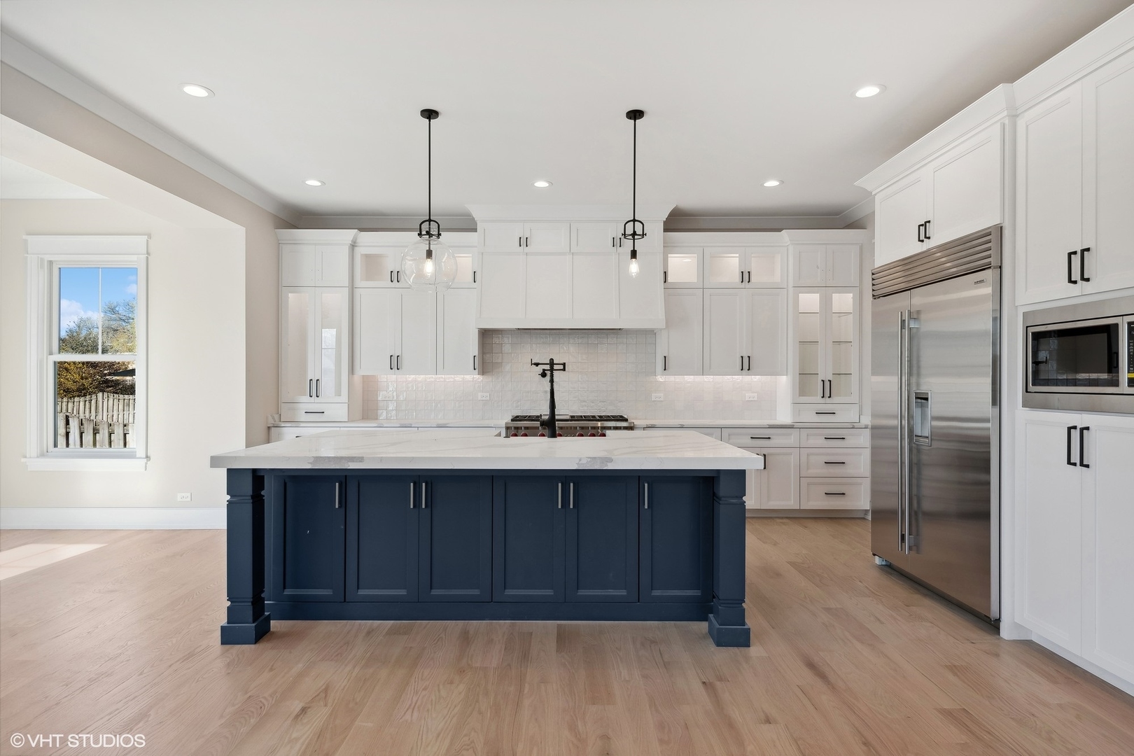 648 Saylor Avenue Elmhurst, IL 60126 - Photo 9 of 27 a large kitchen with stainless steel appliances a large center island attached withe living room