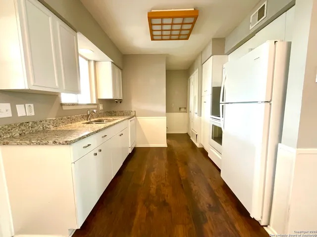 a view of a kitchen with a sink and dishwasher
