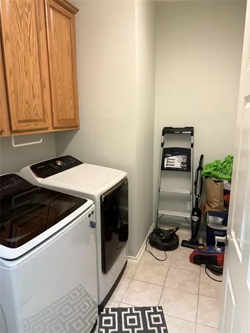 a view of backyard with table and chairs and potted plants