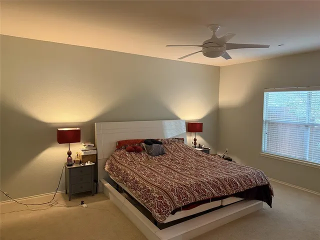 a bedroom with a bed and window