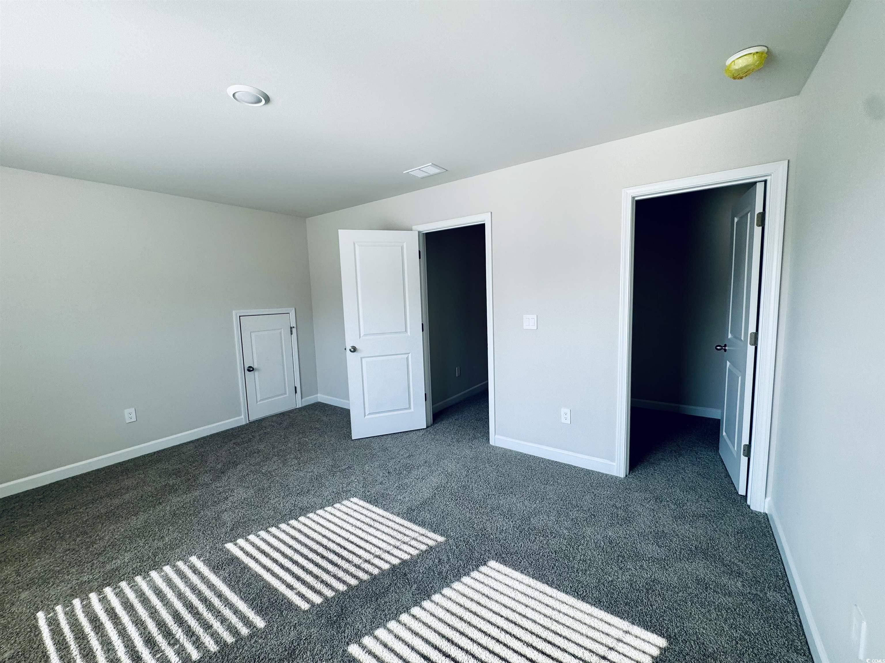 2032 Copper Crk Loop Longs, SC 29568 - Photo 28 of 36 Unfurnished bedroom with a spacious closet, basebo